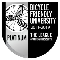 The League of American Bicyclists Platinum Bike Friendly University 2011-2019 Logo Black and Silver with Bike Wheel and Wing Design